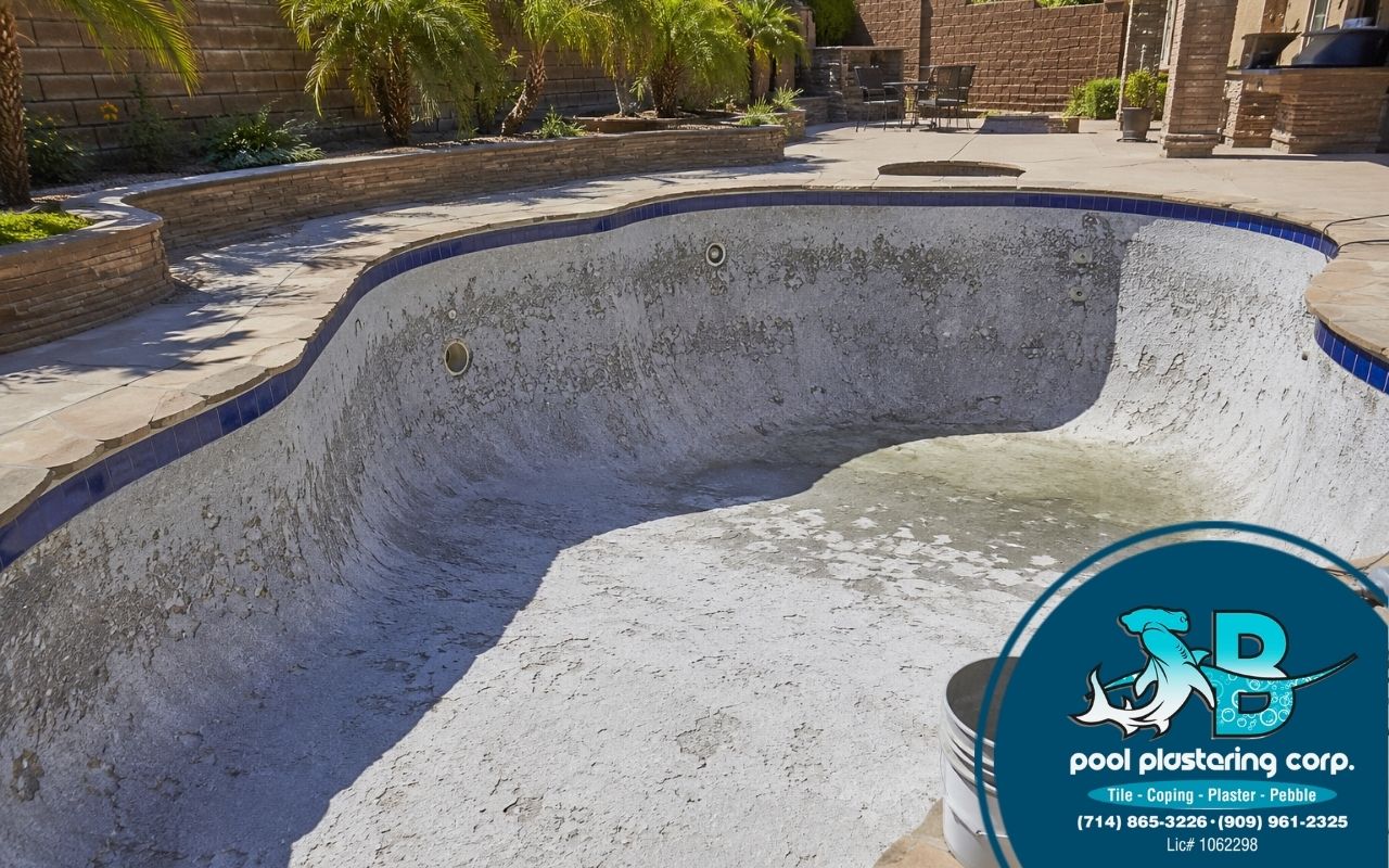 Black spots in pool plaster in Southern California showing dark surface stains.
